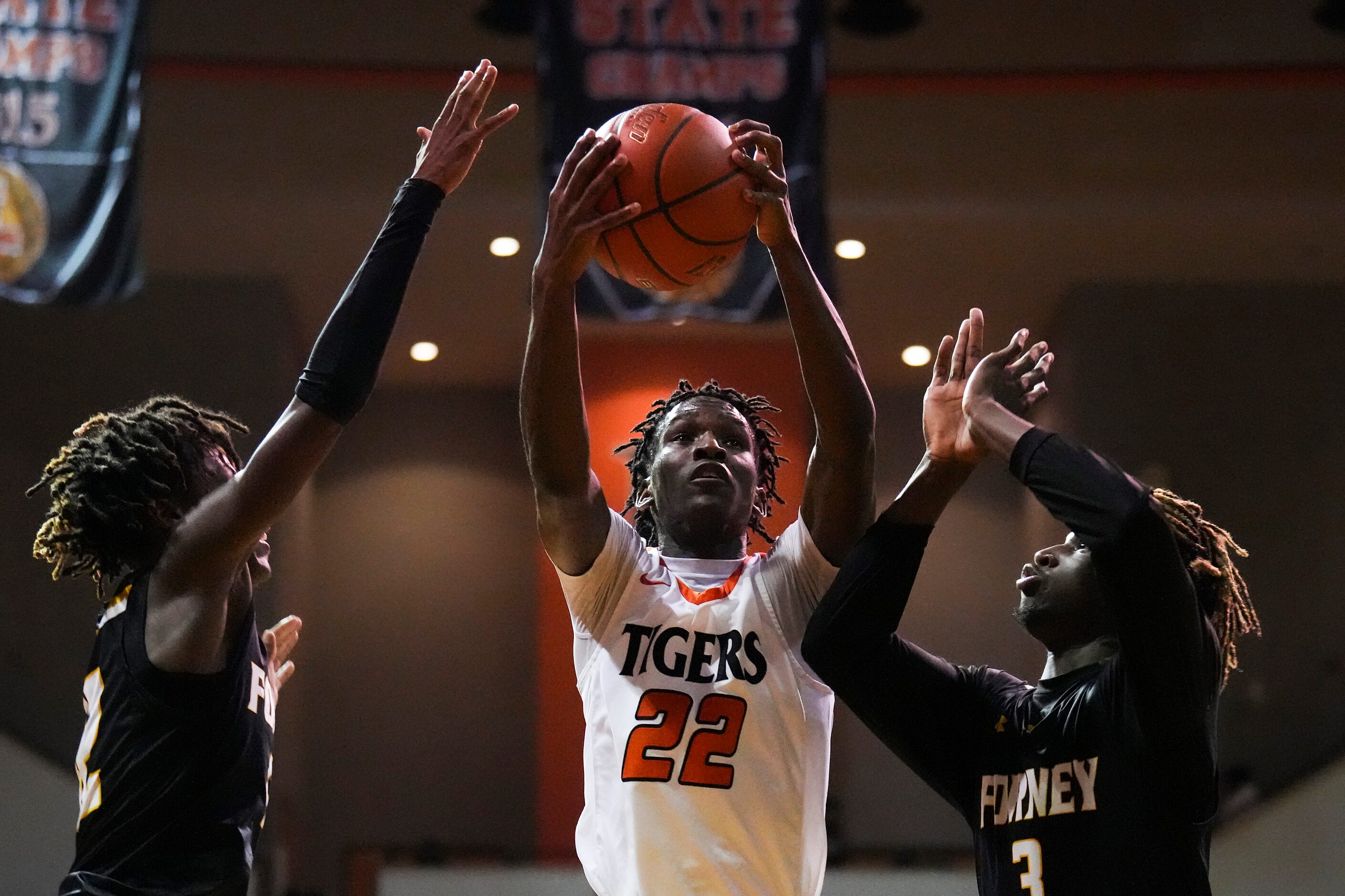 Lancaster's Jordan Williams (22) drives to the basket as Forney guardsJaden Jefferson (3)...