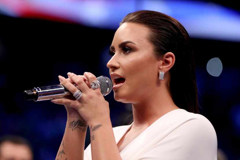 LAS VEGAS, NV - AUGUST 26:  Singer Demi Lovato performs the national anthem prior to the...
