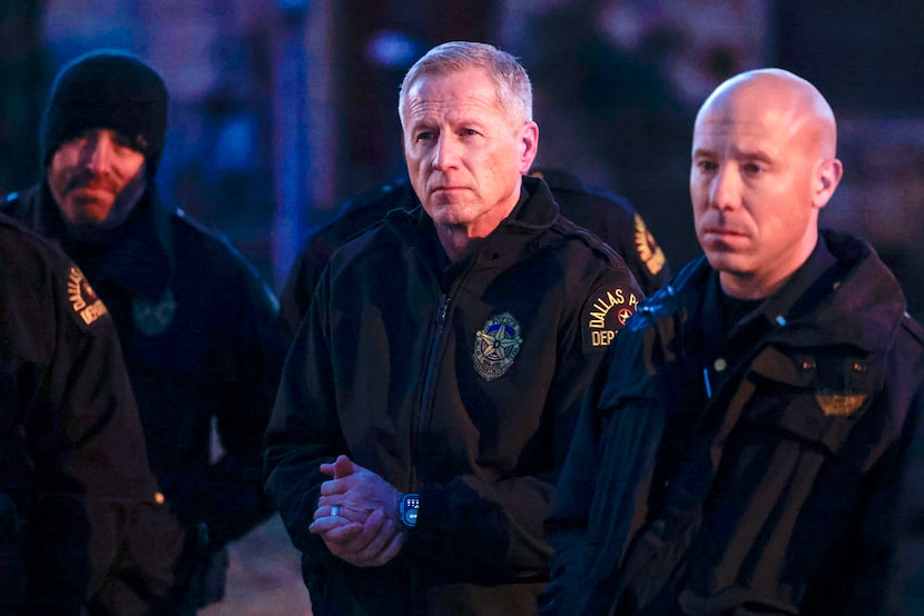 Interim Dallas police Chief Michael Igo (center) listens as police provide an update...