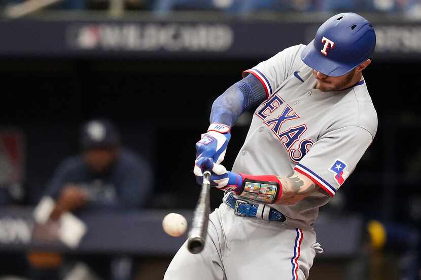 Texas Rangers catcher Jonah Heim singles during the second inning of an American League Wild...