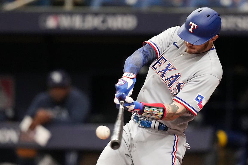 Texas Rangers catcher Jonah Heim singles during the second inning of an American League Wild...