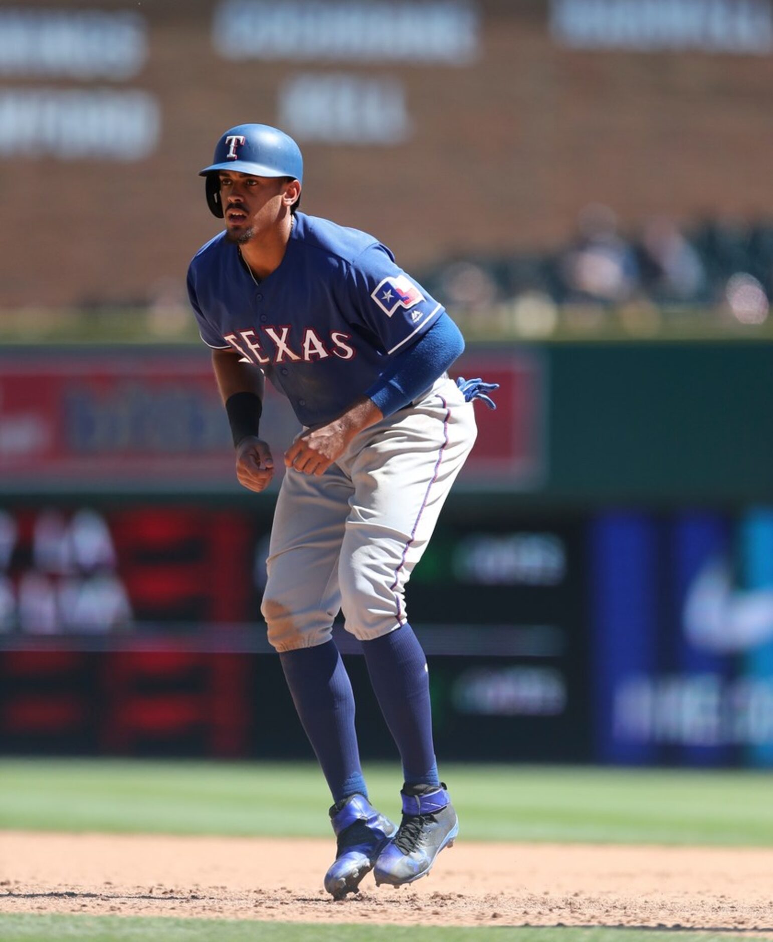 Texas Rangers' Ronald Guzman leads off first base during the ninth inning of a baseball game...