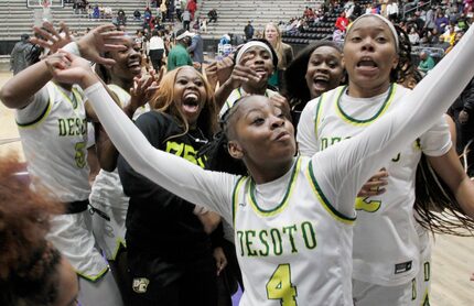 DeSoto guard Ja'Mia Harris (4) captures a video as she celebrates with teammates following...