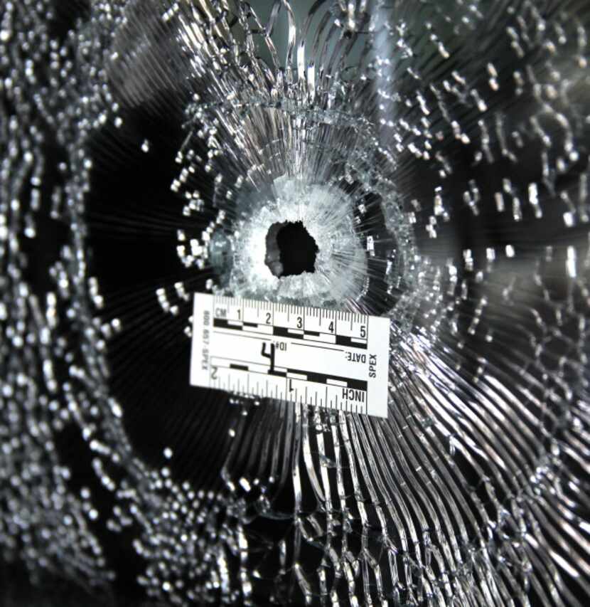 This is one of many bullet holes that were marked by Dallas police on the party bus.