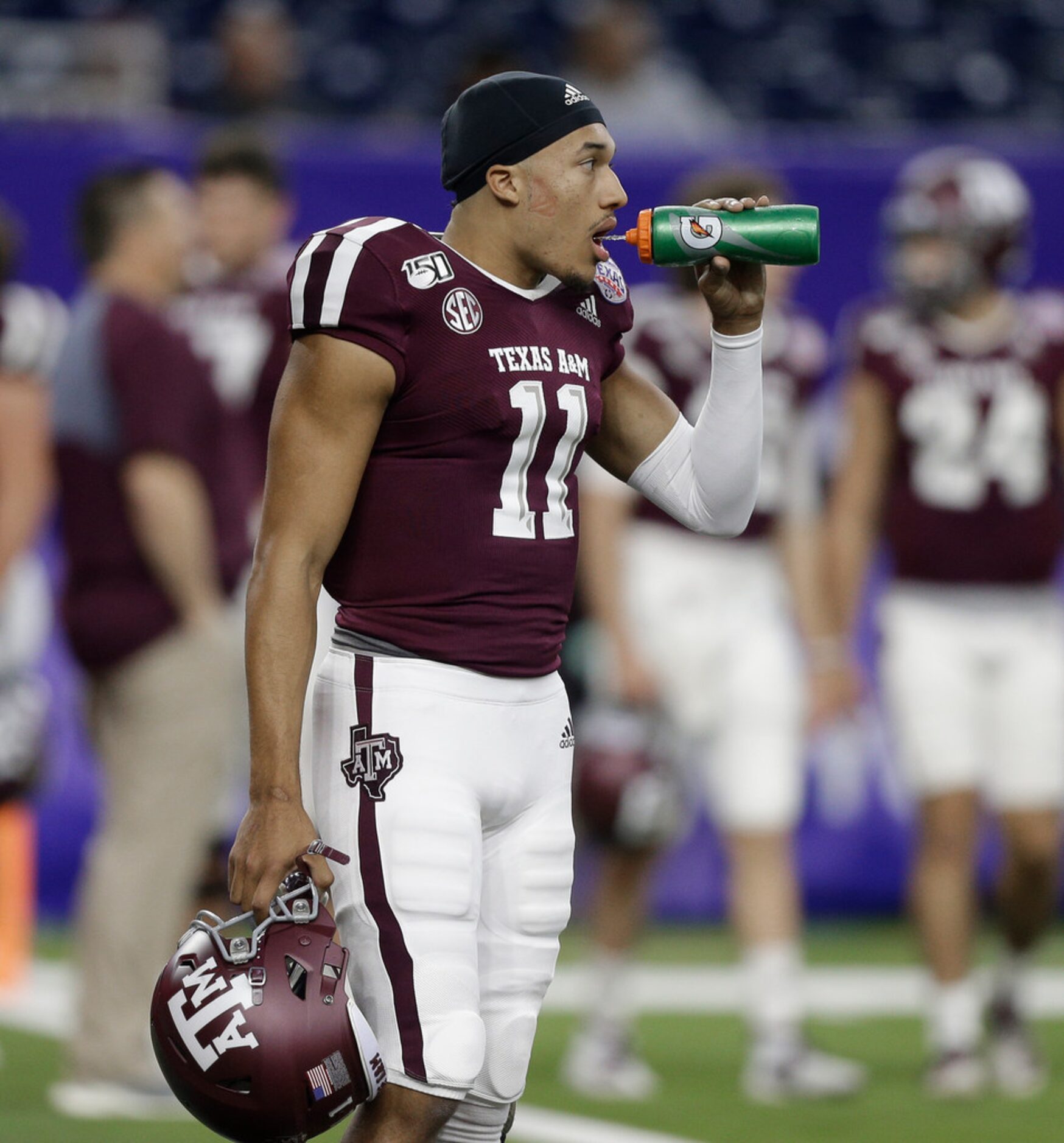 HOUSTON, TEXAS - DECEMBER 27: Kellen Mond #11 of the Texas A&M Aggies warms up before...