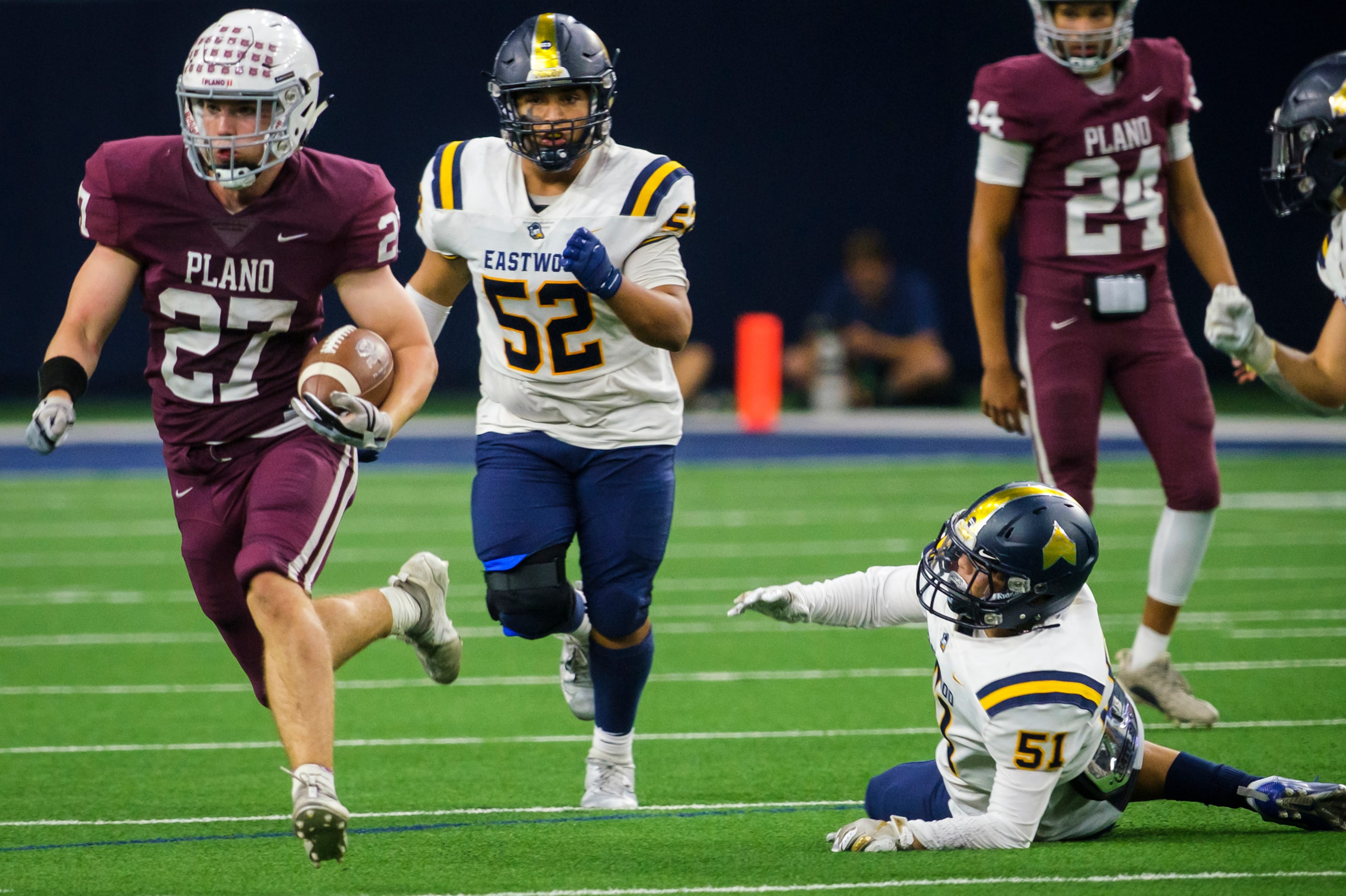 Plano running back Cody Crist (27) gets pas El Paso Eastwood defensive linemen Vincent...