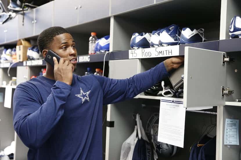 Rod Smith grabs items out of his new locker in the Dallas Cowboys locker room at Valley...