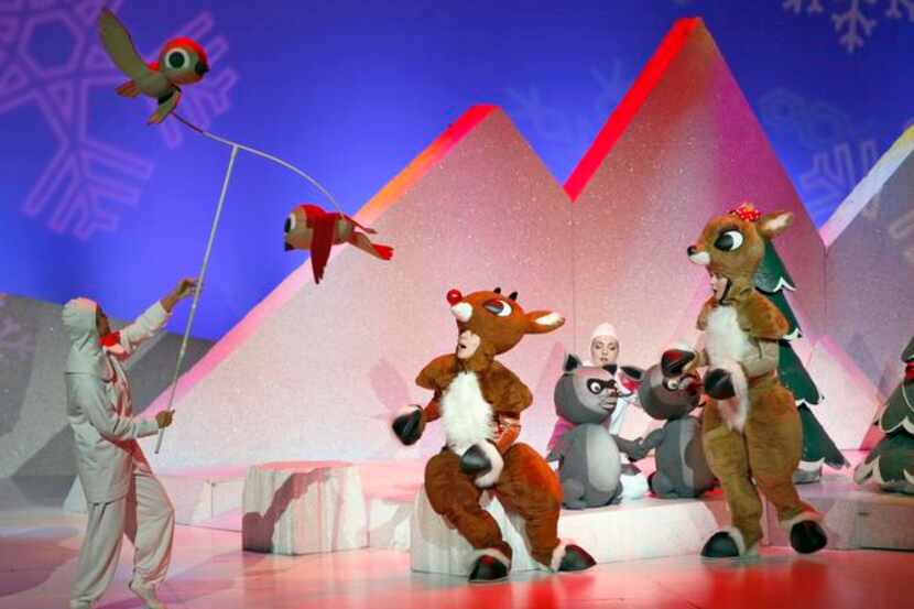
A puppeteer controls the movements of birds flying over the heads of Rudolph and Clarice in...