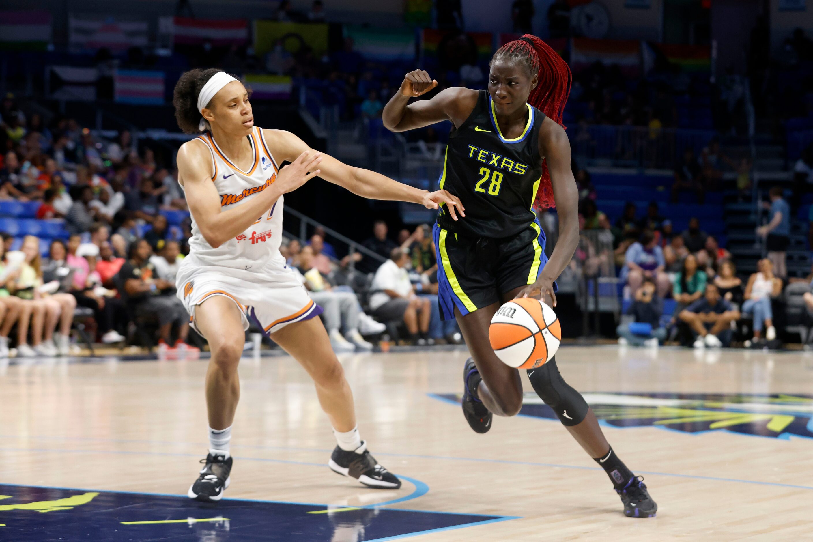 Dallas Wings center Awak Kuier (28) drives past Phoenix Mercury forward Brianna Turner (21)...