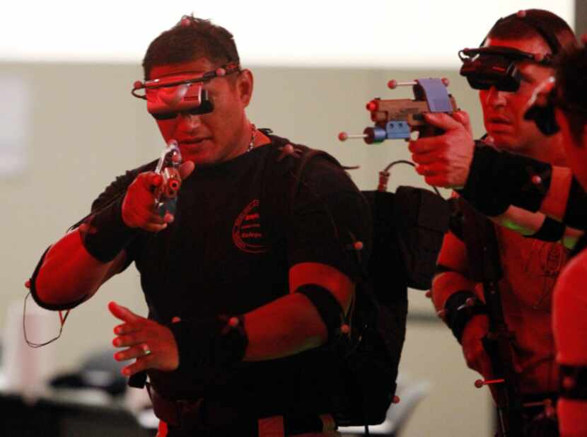 McKinney officers work a virtual reality scenario displayed by VIRTSIM equipment.