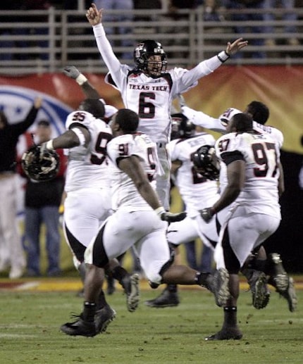 FILE - Texas Tech quarterback Graham Harrell (6) celebrates with teammates moments after...