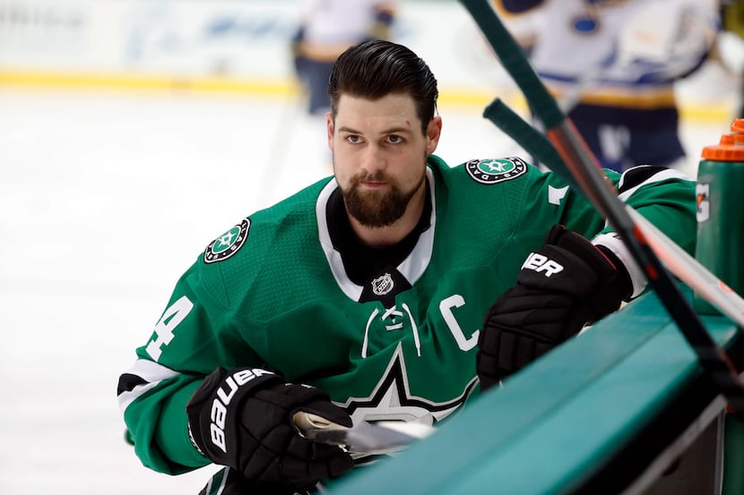 Dallas Stars left wing Jamie Benn (14) stretches by the bench during warm ups before an NHL...