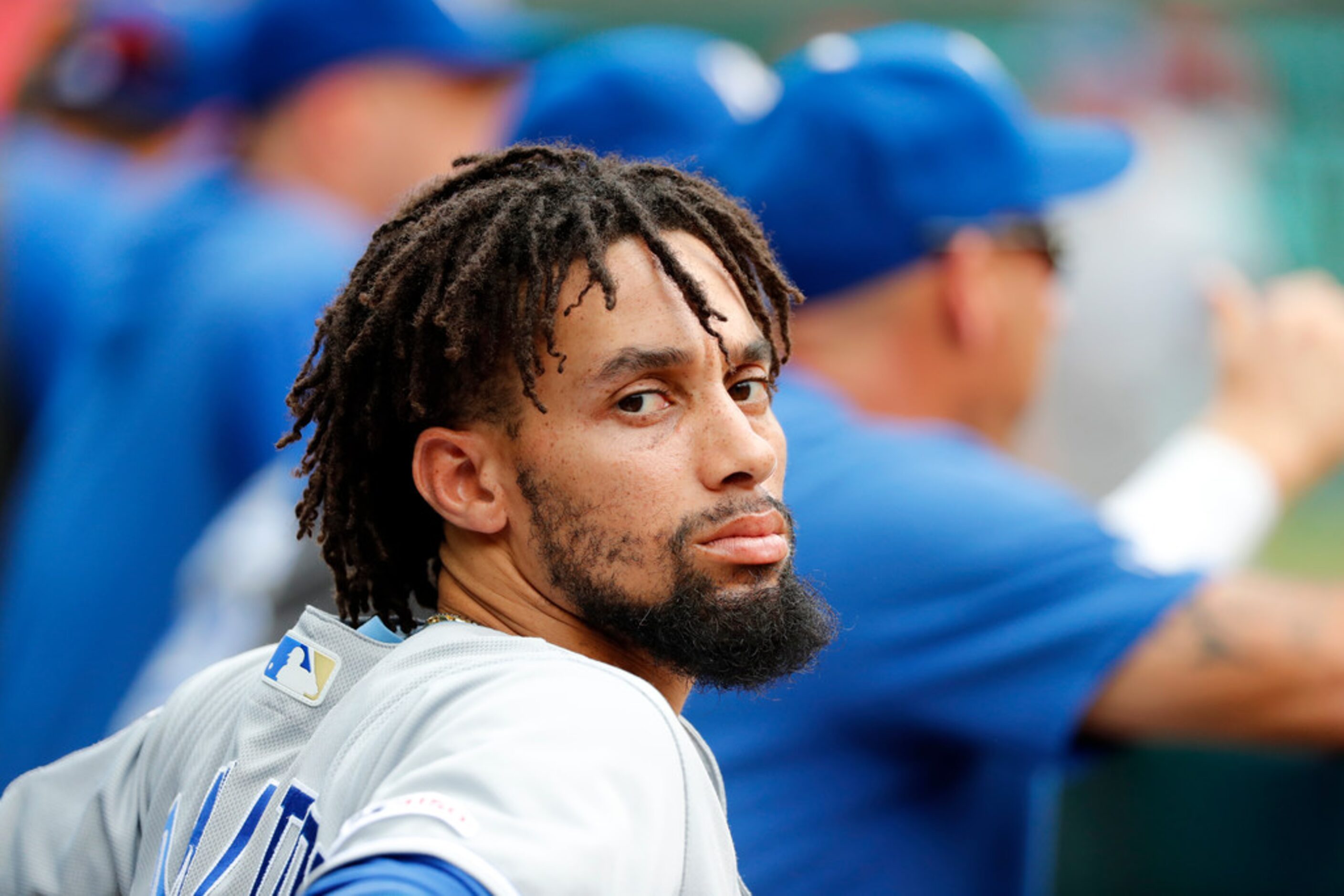 Kansas City Royals' Billy Hamilton sits in the dugout in the first inning of a baseball game...