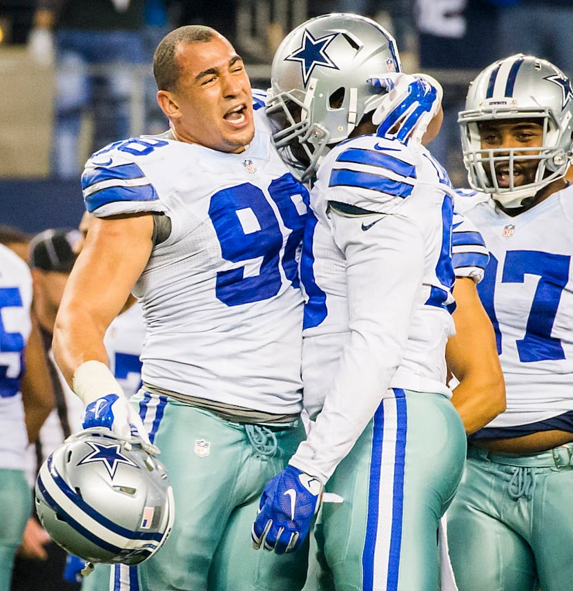 Dallas Cowboys defensive end DeMarcus Lawrence (90) celebrates with teammate Tyrone Crawford...
