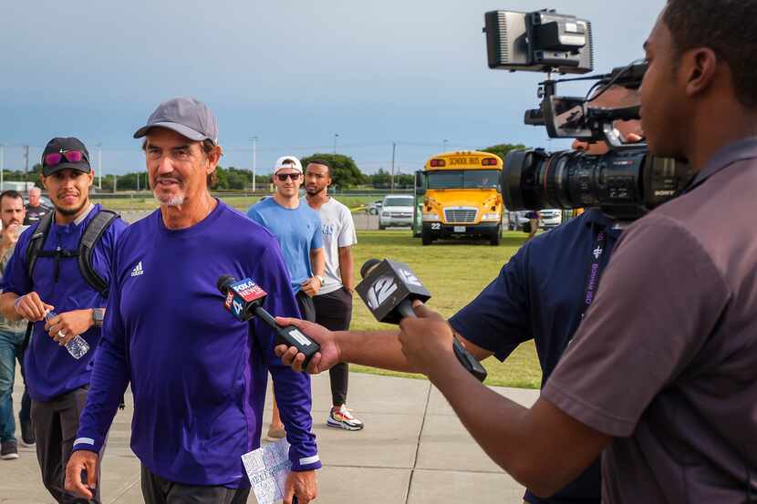 Art Briles talks to reporters after getting off the team bus before his team's...