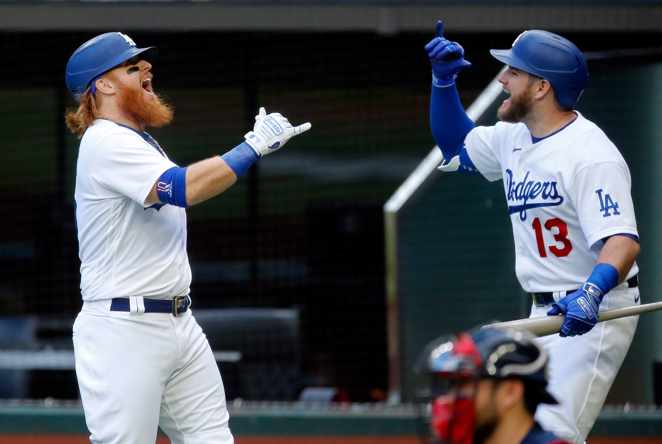 Los Angeles Dodgers Justin Turner (10) is congratulated on his first inning solo home run by...