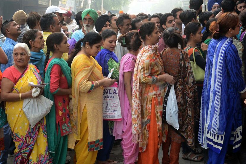 Indian bank customers wait to deposit Indian currency notes at a bank in  Amritsar. (Agence...