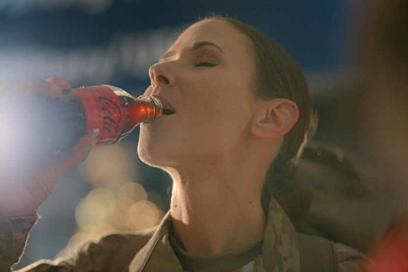 Service member drinking a Coke