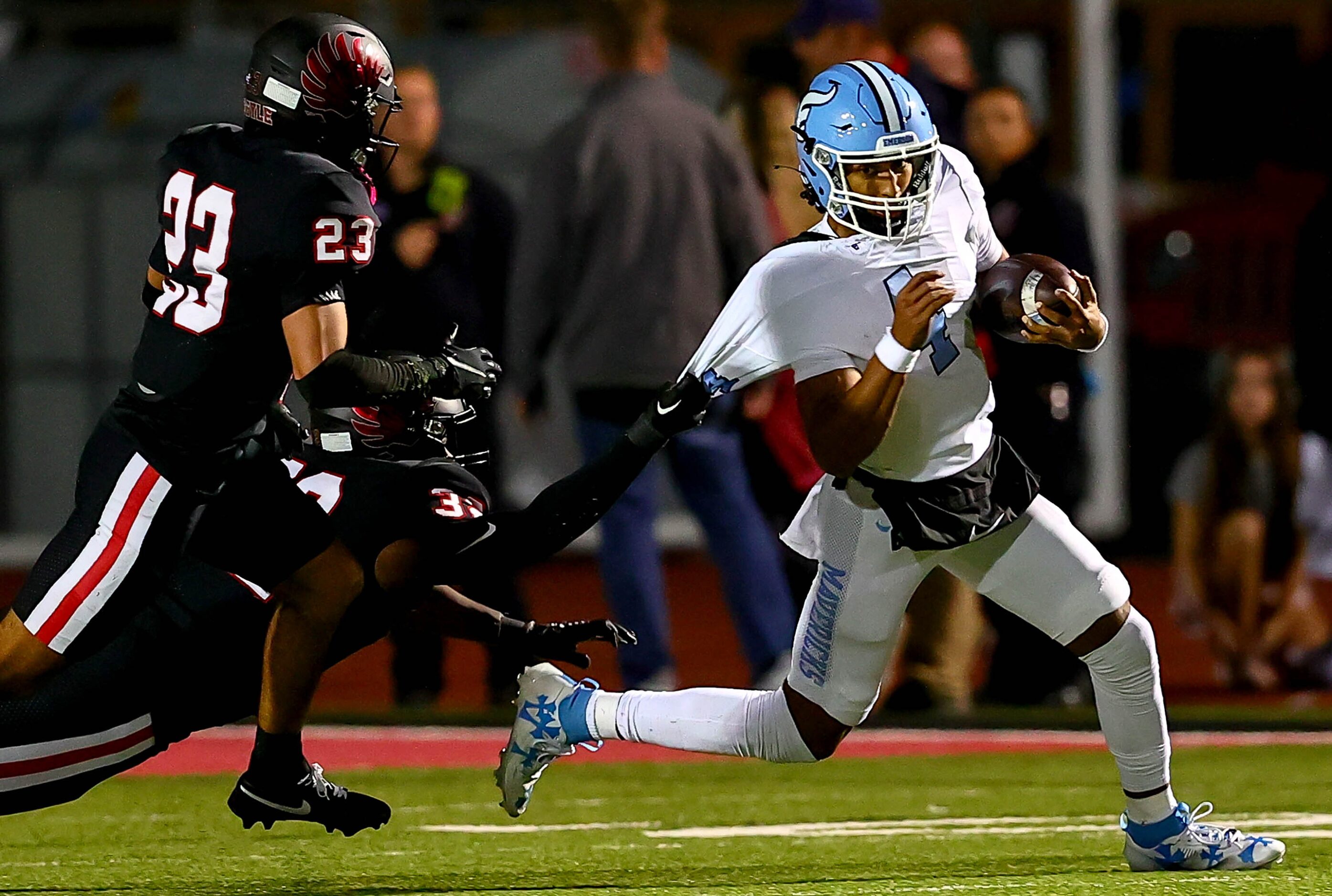 Frisco Emerson quarterback Michael Hawkins (4) tries to make the corner but gets his jersey...