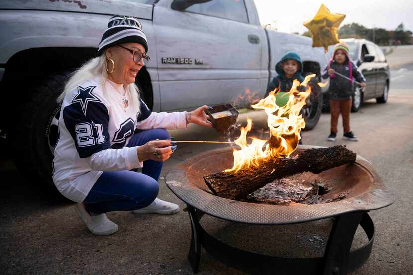 Nora Duarte lights a fire pit during her grandson’s birthday/Cowboys watch party on Nov. 13,...