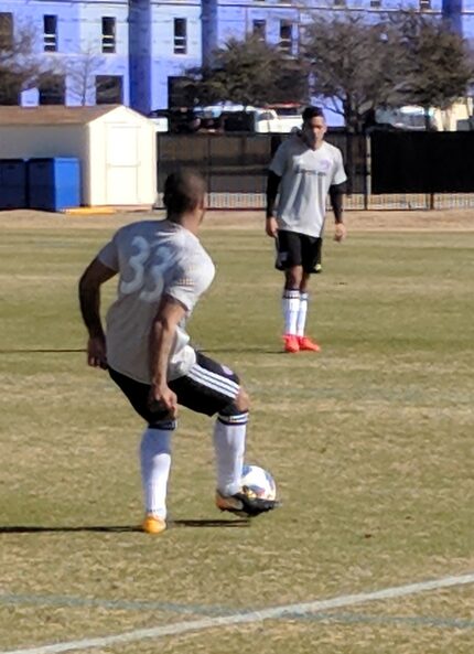 Kevin Ellis, wearing #33, passes to Victor Ulloa of FC Dallas while playing against OKC...