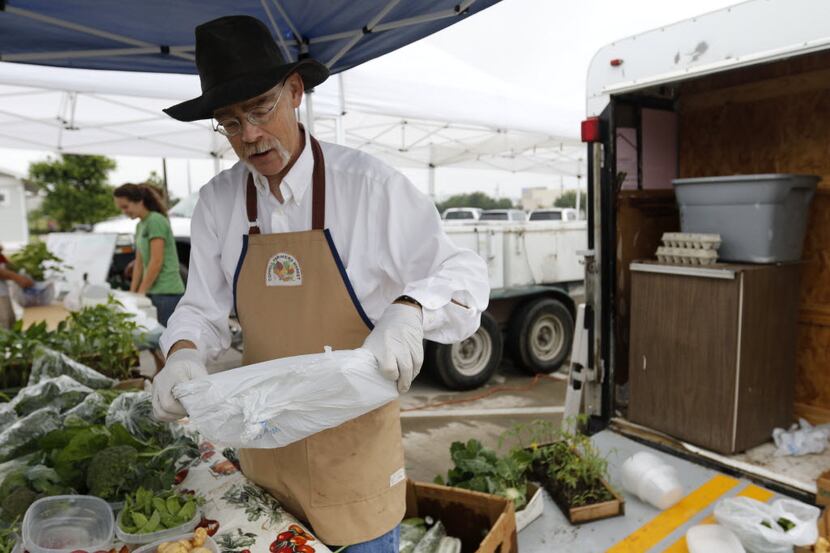 Chris Buckalew from Weathertop Farm in Montague County sells produce at the Coppell Farmers...