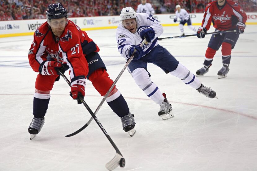 WASHINGTON, DC - APRIL 13: Karl Alzner #27 of the Washington Capitals and Connor Brown #12...