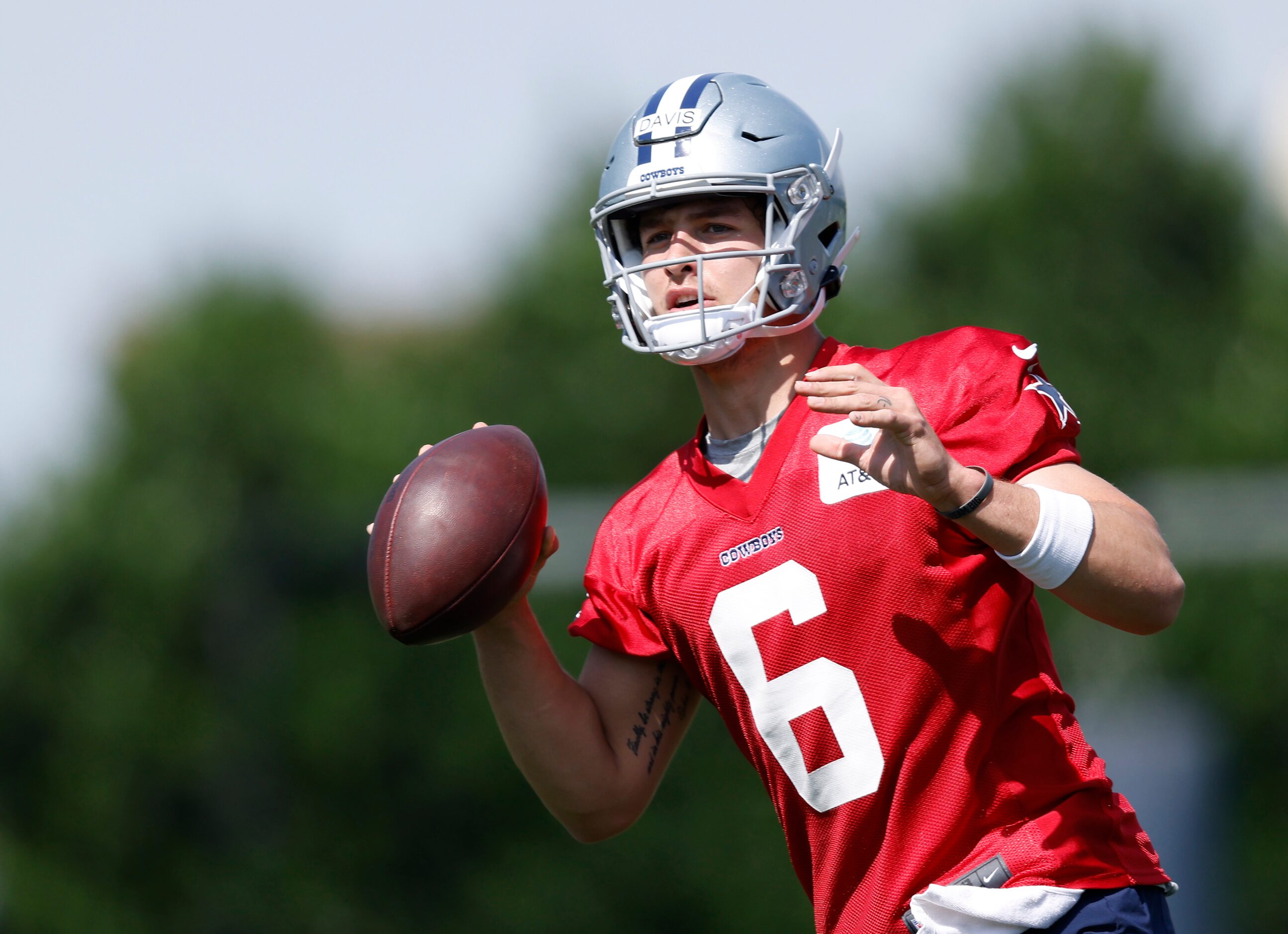 Dallas Cowboys rookie quarterback Brady Davis (6) throws o the run during rookie minicamp at...