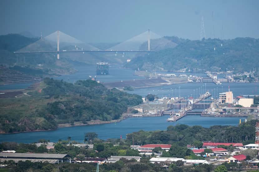 A cargo ship waits near the Centennial Bridge for transit through the Panama Canal locks in...