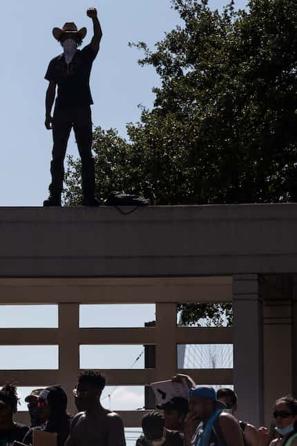 Protesters gathered at the Grassy Knoll during a demonstration denouncing police brutality...