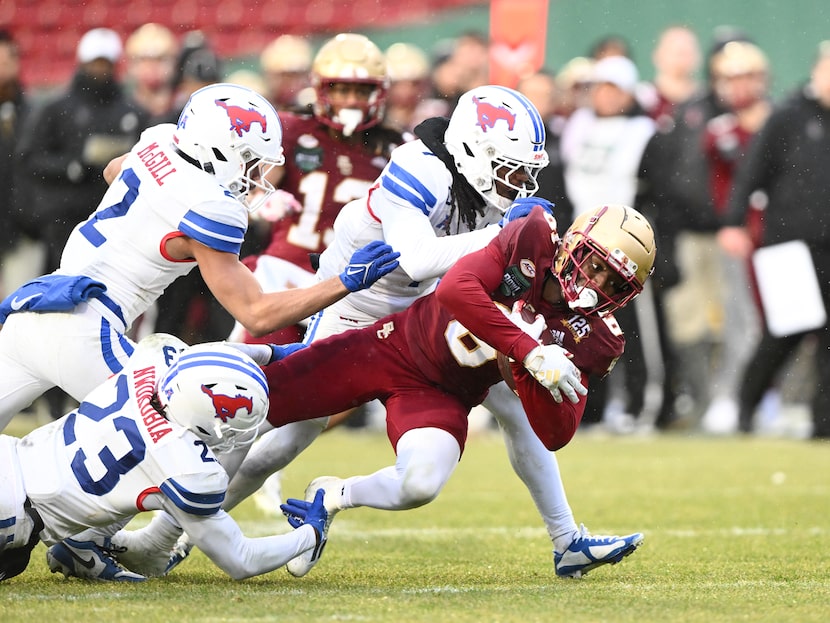 BOSTON, MASSACHUSETTS - DECEMBER 28: Jaedn Skeete #6 of the Boston College Eagles is tackled...