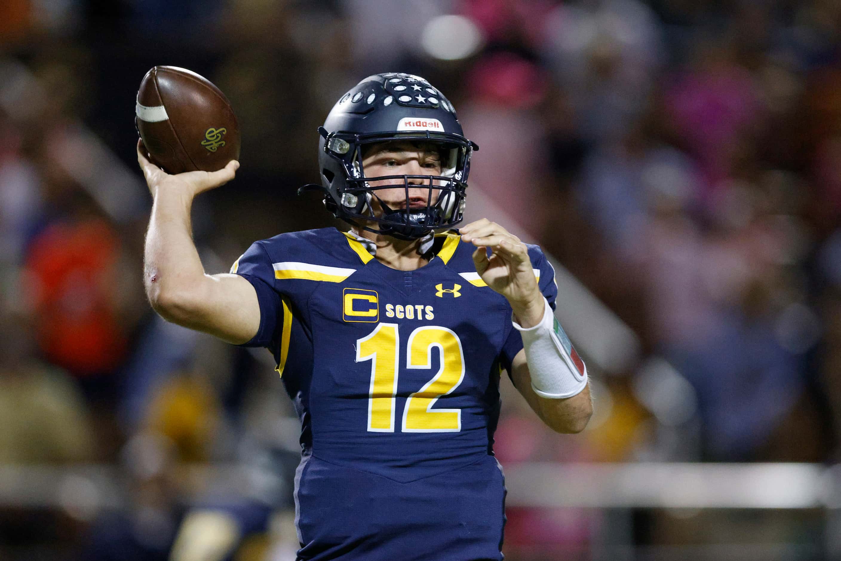 Highland Park quarterback Warren Peck (12) throws a pass during the first half of a District...