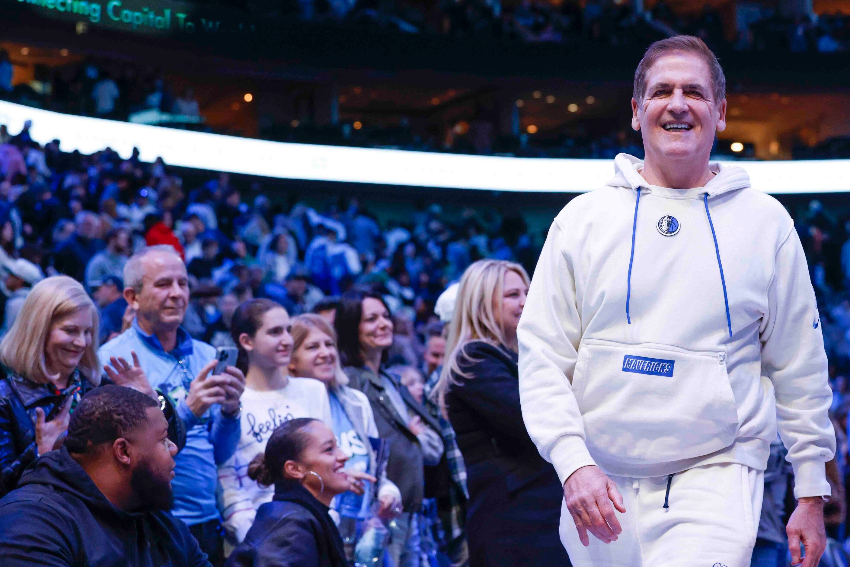 Dallas Mavericks owner Mark Cuban smiles as he leaves after an NBA game against Portland...