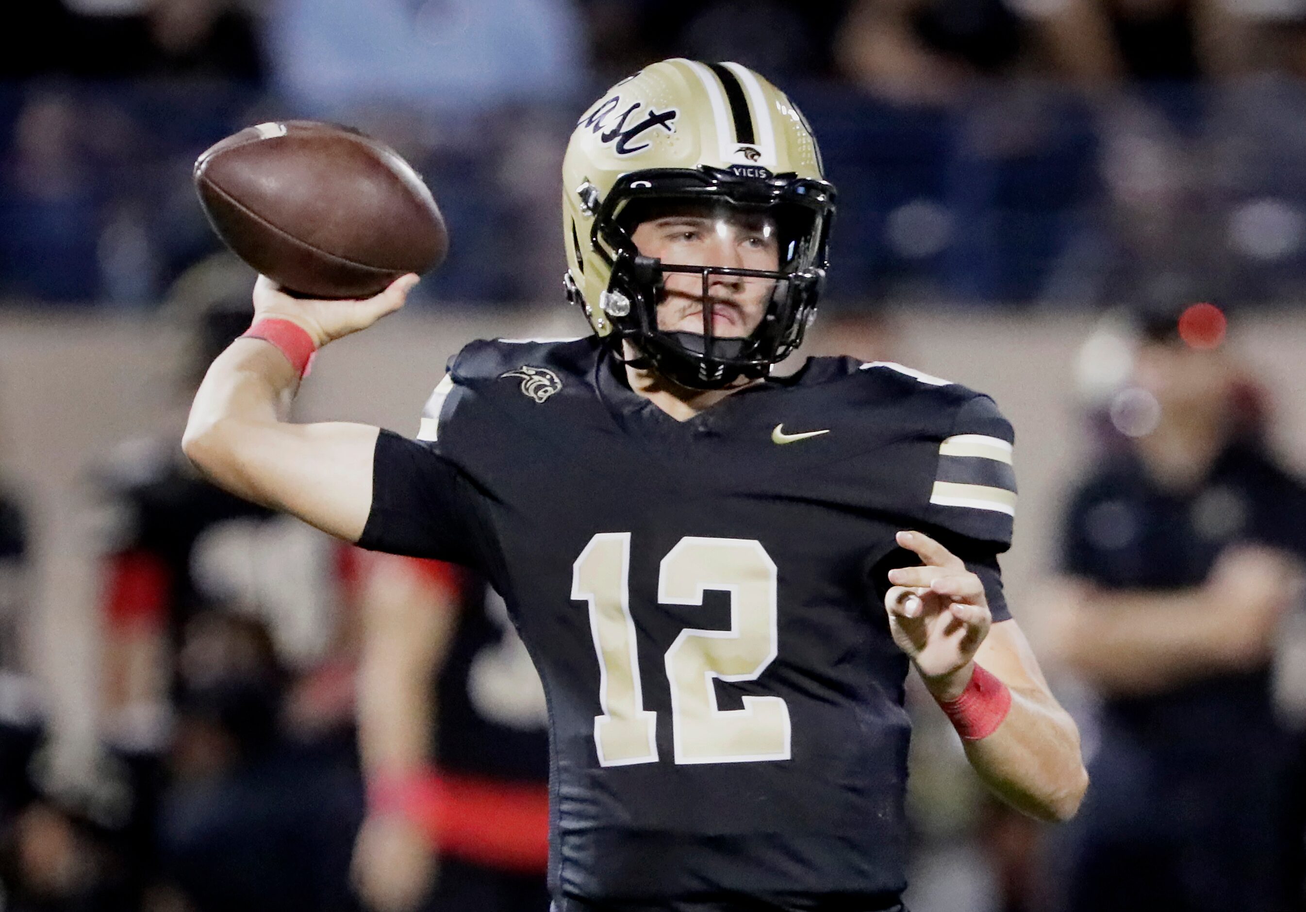 Plano East High School quarterback Jackson Hays (12) throws a pass during the first half as...