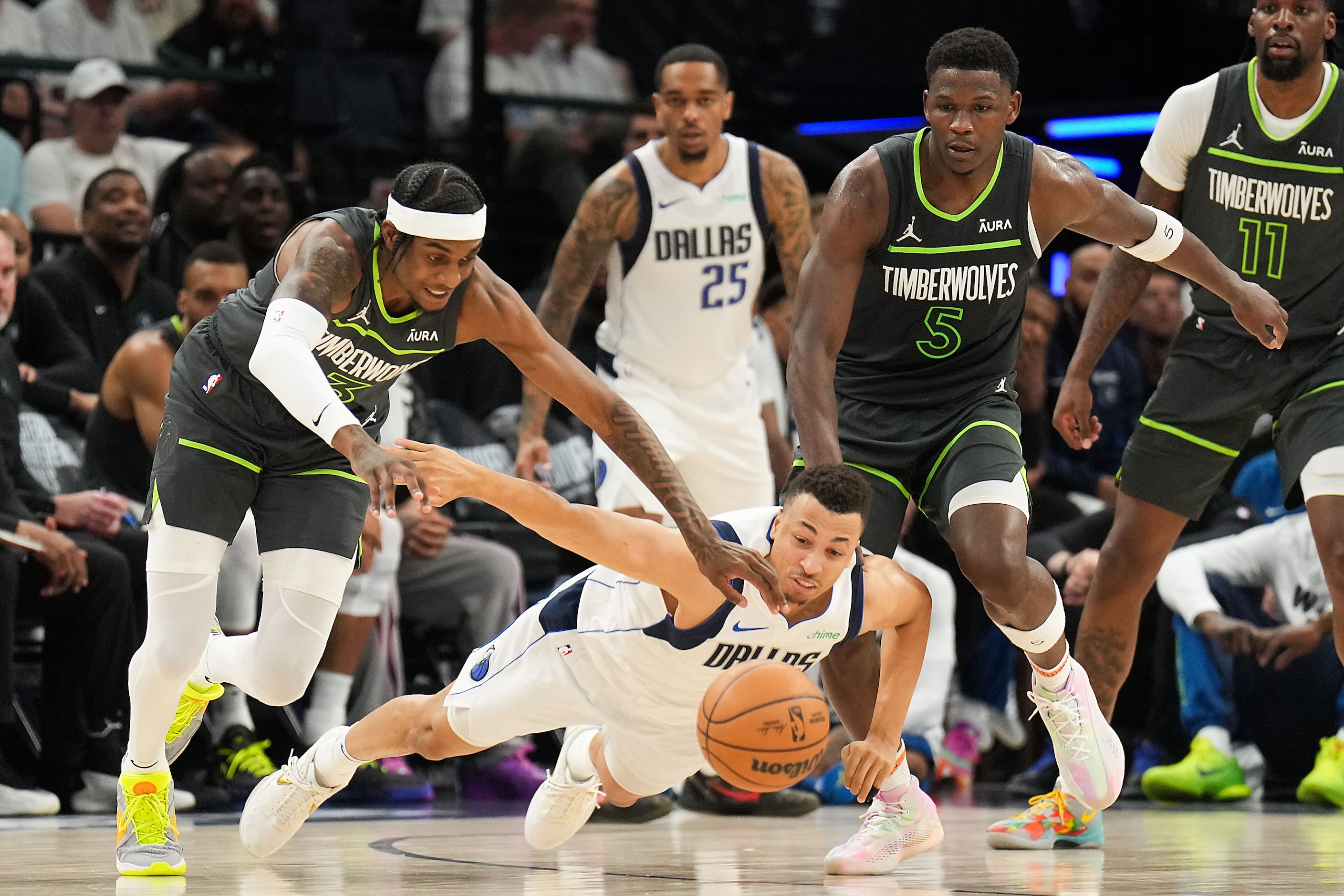 Dallas Mavericks guard A.J. Lawson (9) dives for a loose ball against Minnesota Timberwolves...