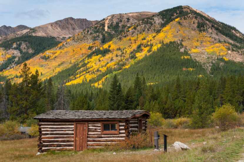 A cabin in Winfield stands against a backdrop of golden aspen. The town grew quickly with...