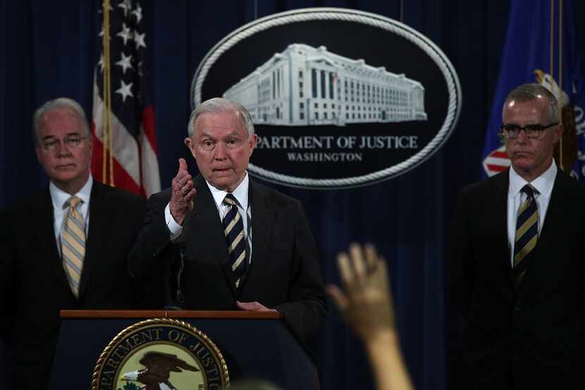 U.S. Attorney General Jeff Sessions takes questions as Acting FBI Director Andrew McCabe...