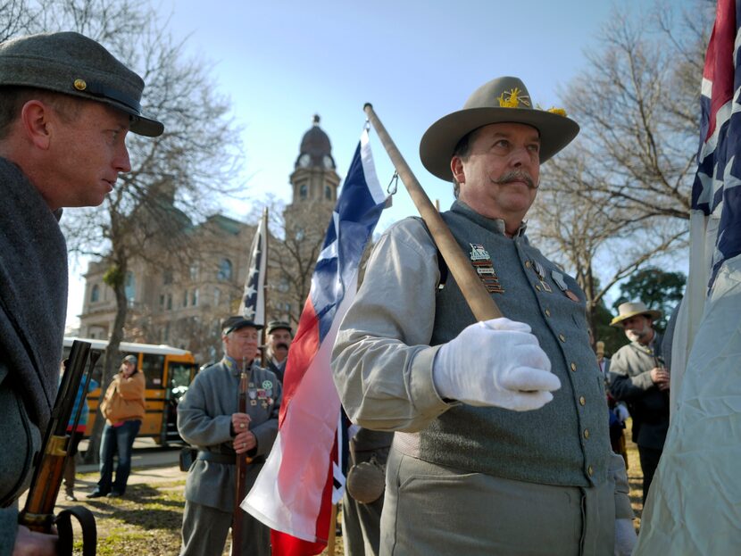 Sons of Confederate Veterans, including Michael Lee Garrett, right, wait for the Fort Worth...