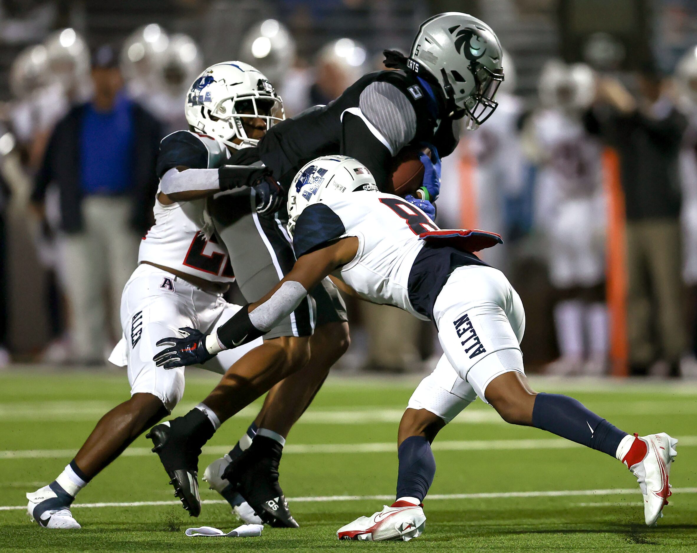 Denton Guyer wide receiver Jace Wilson (5) brought down by Allen defensive back Tru Willford...