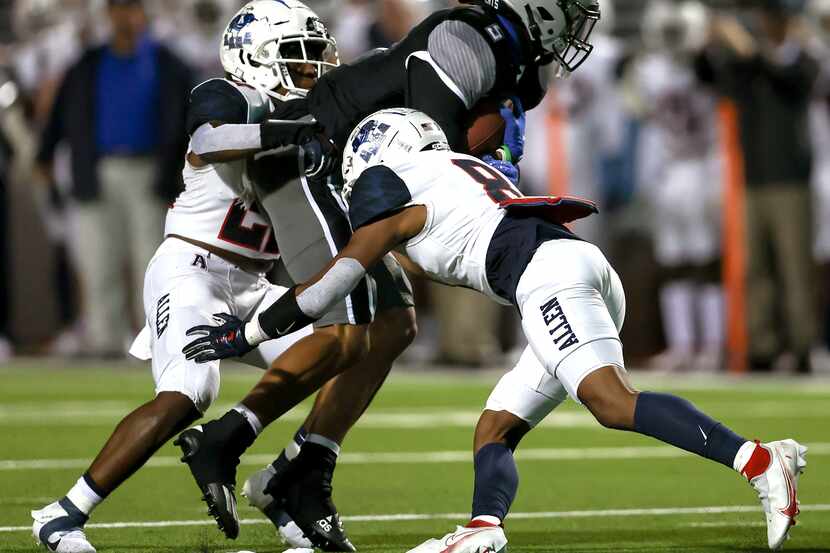 Denton Guyer wide receiver Jace Wilson (5) brought down by Allen defensive back Tru Willford...