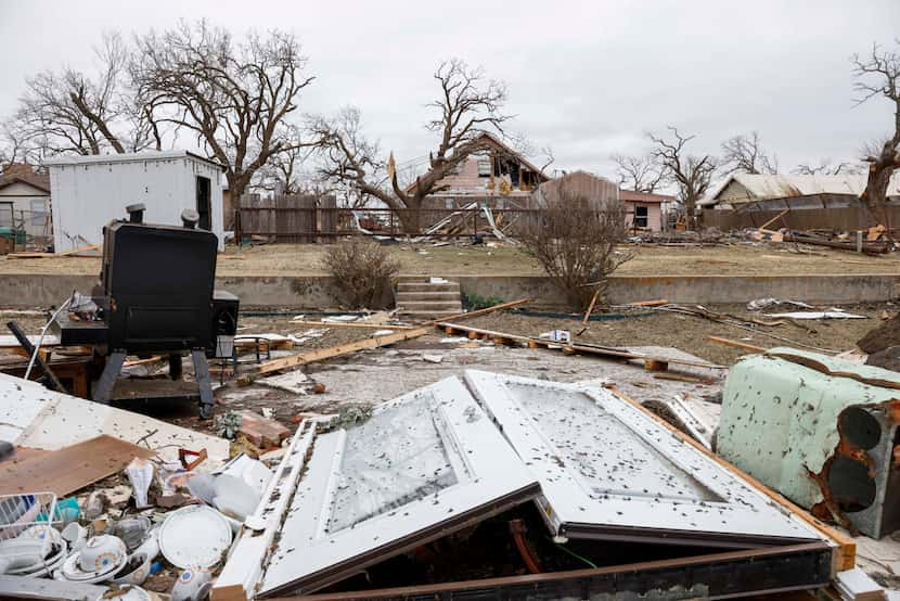 The back doors of Dorothy Maddox's house lay in shambles after a possible tornado damaged...