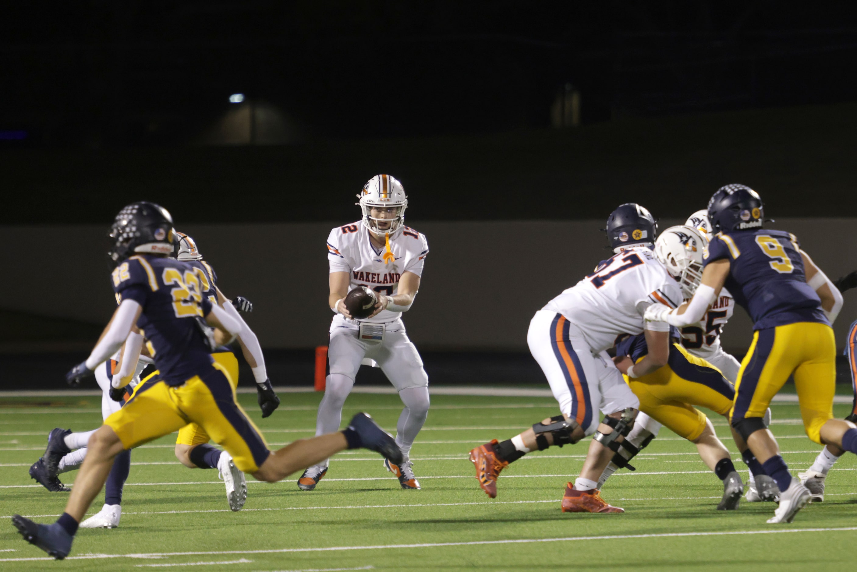 Frisco Wakeland quarterback Jayden Maples receives a snap in a high school football playoff...