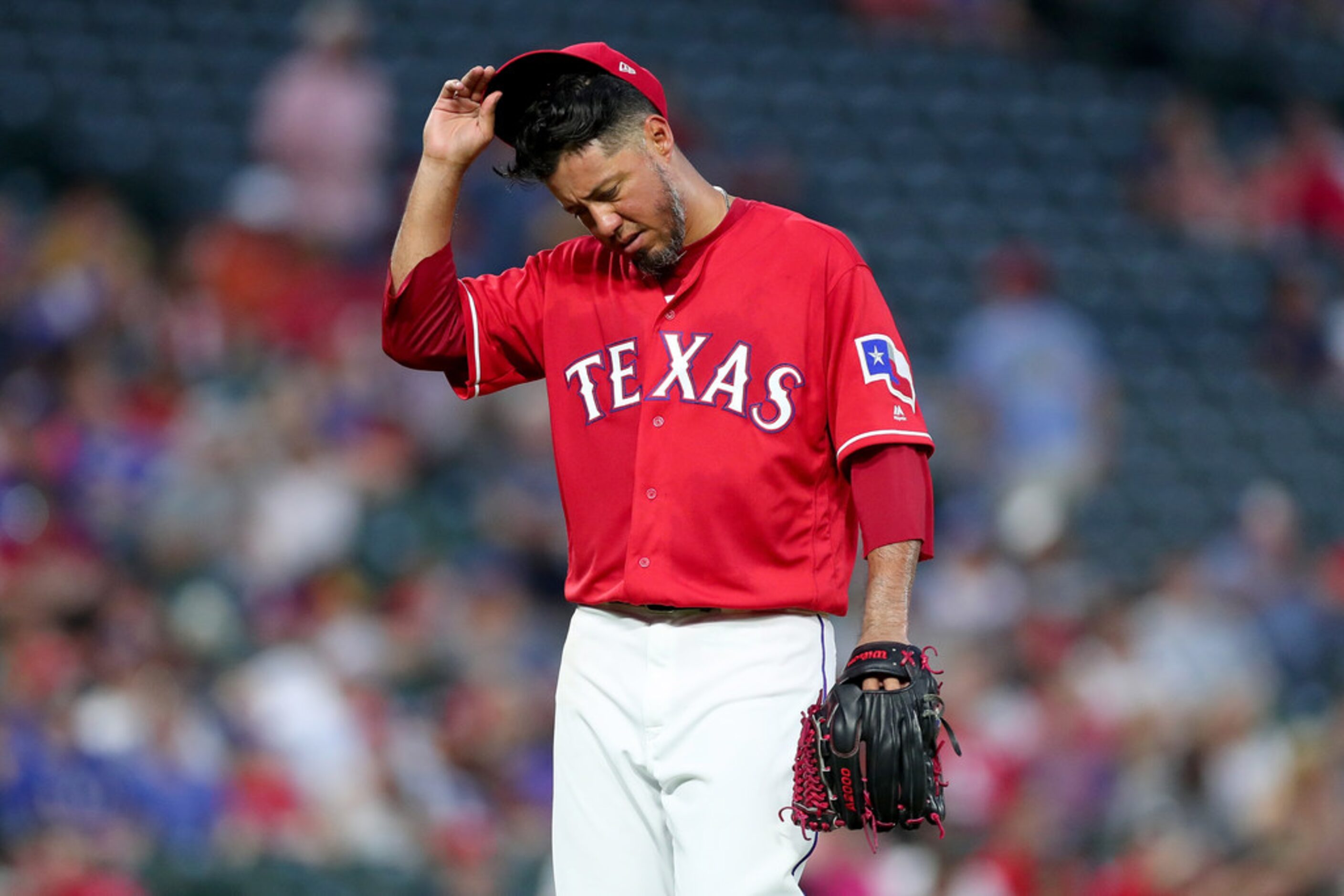 ARLINGTON, TX - AUGUST 14:  Yovani Gallardo #49 of the Texas Rangers reacts after being...