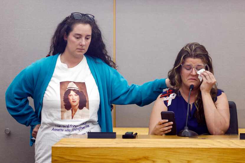 Kelly Flowers (right) wipes away tears as she gives a victim impact statement alongside her...