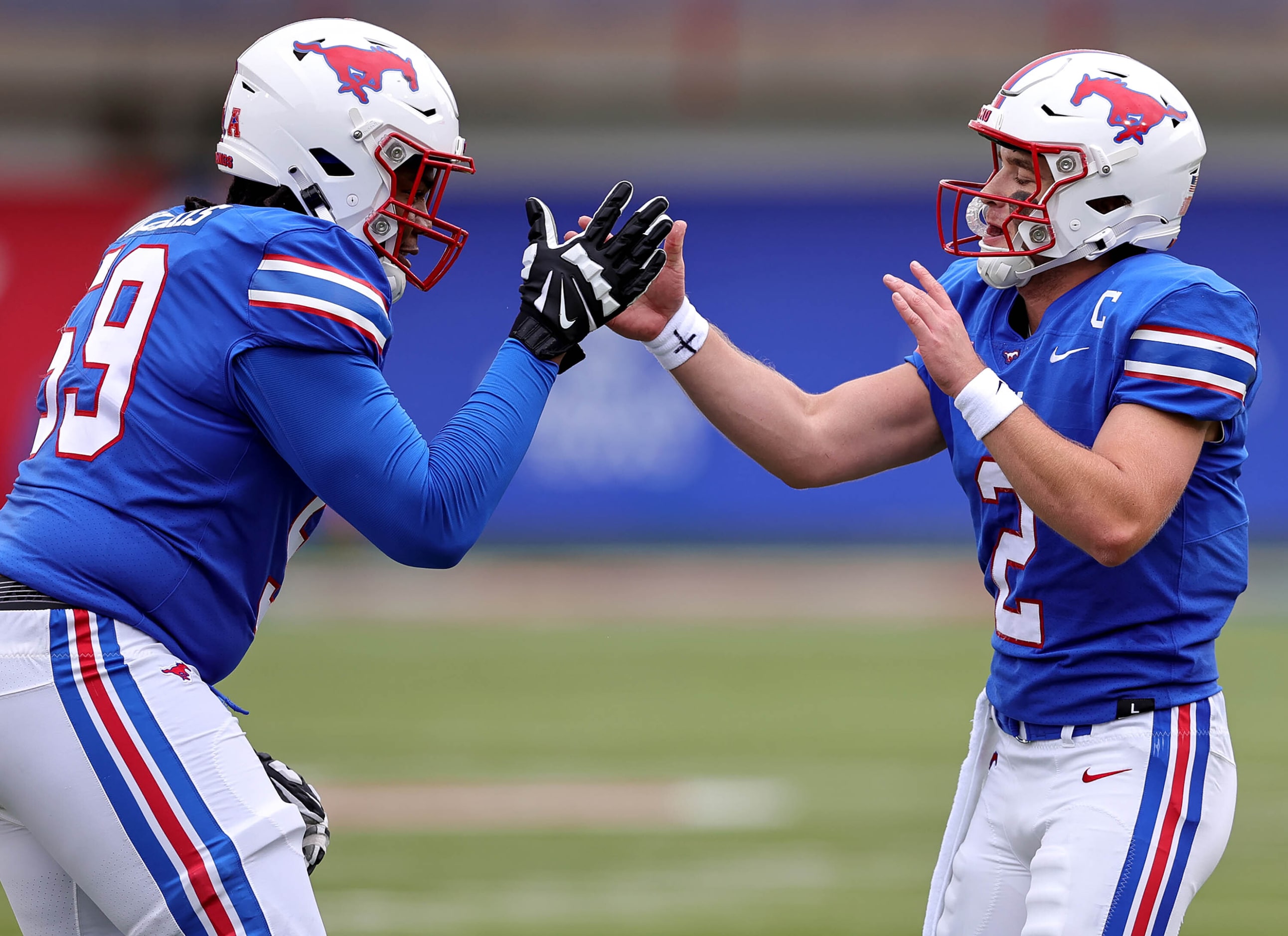 SMU quarterback Preston Stone (2) celebrates with left tackle PJ Williams (59) after a Stone...