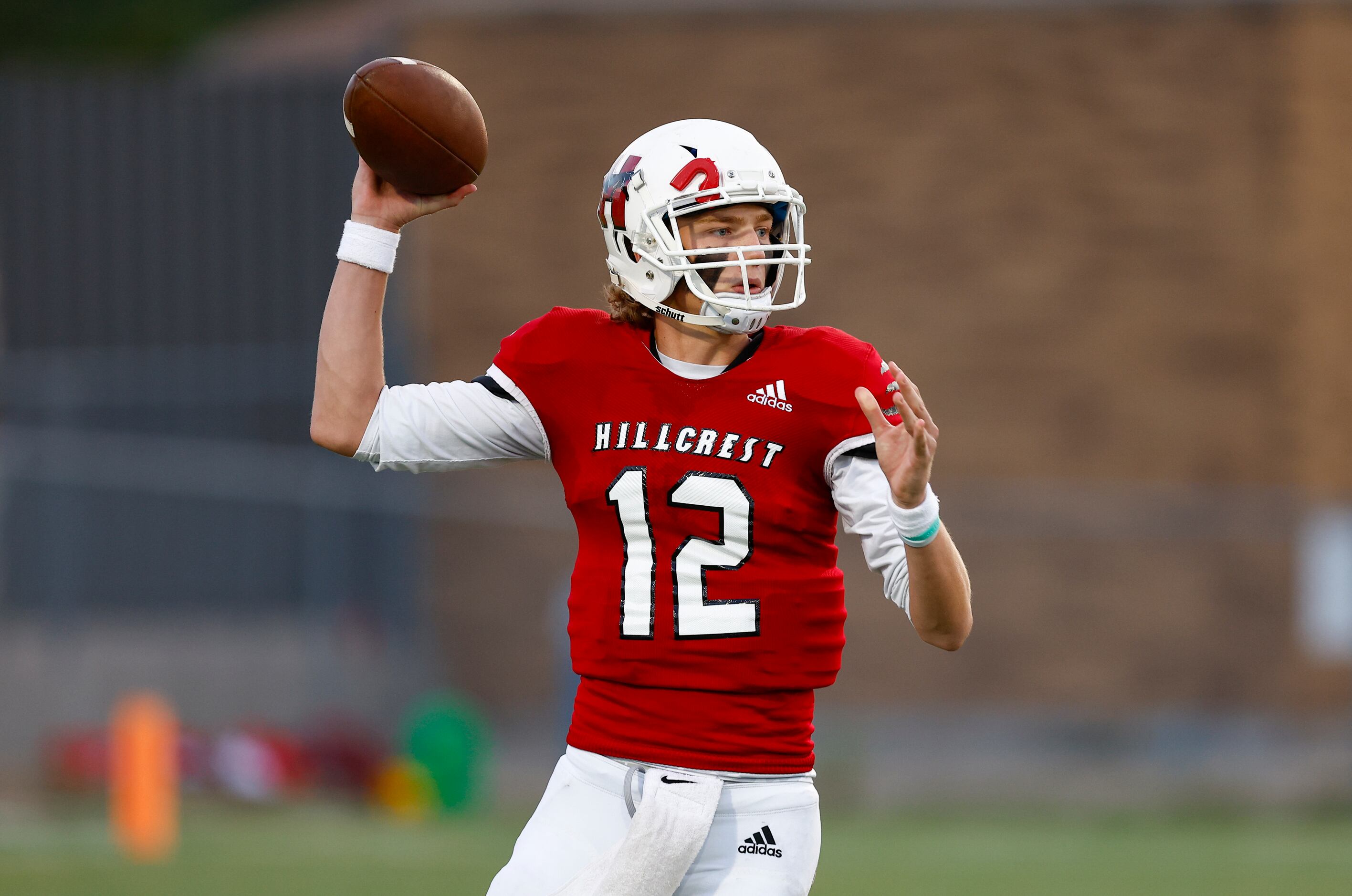Hillcrest junior quarterback Luke Monter (12) throws during the first half of a high school...
