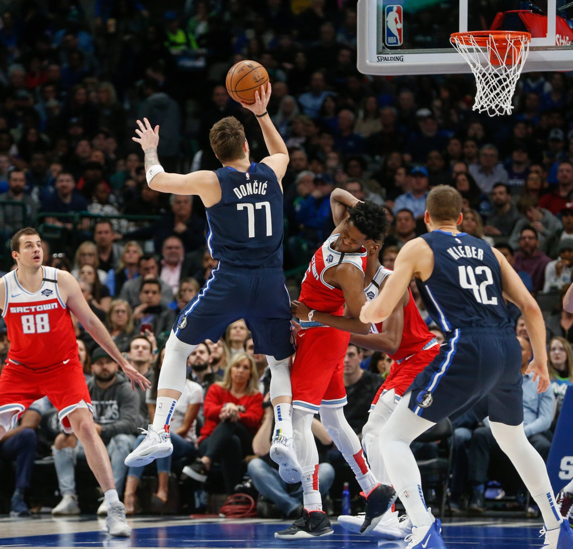 Dallas Mavericks guard Luka Doncic (77) goes up for a shot during the first half of an NBA...