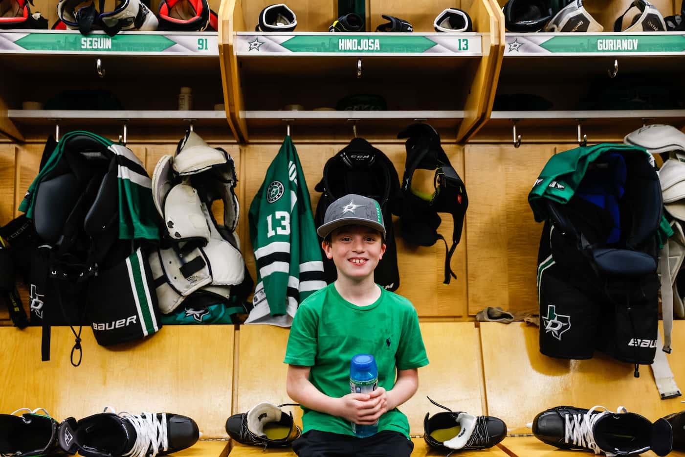 Max Hinojosa, 9, poses for a portrait at his assigned locker in the locker room of the...