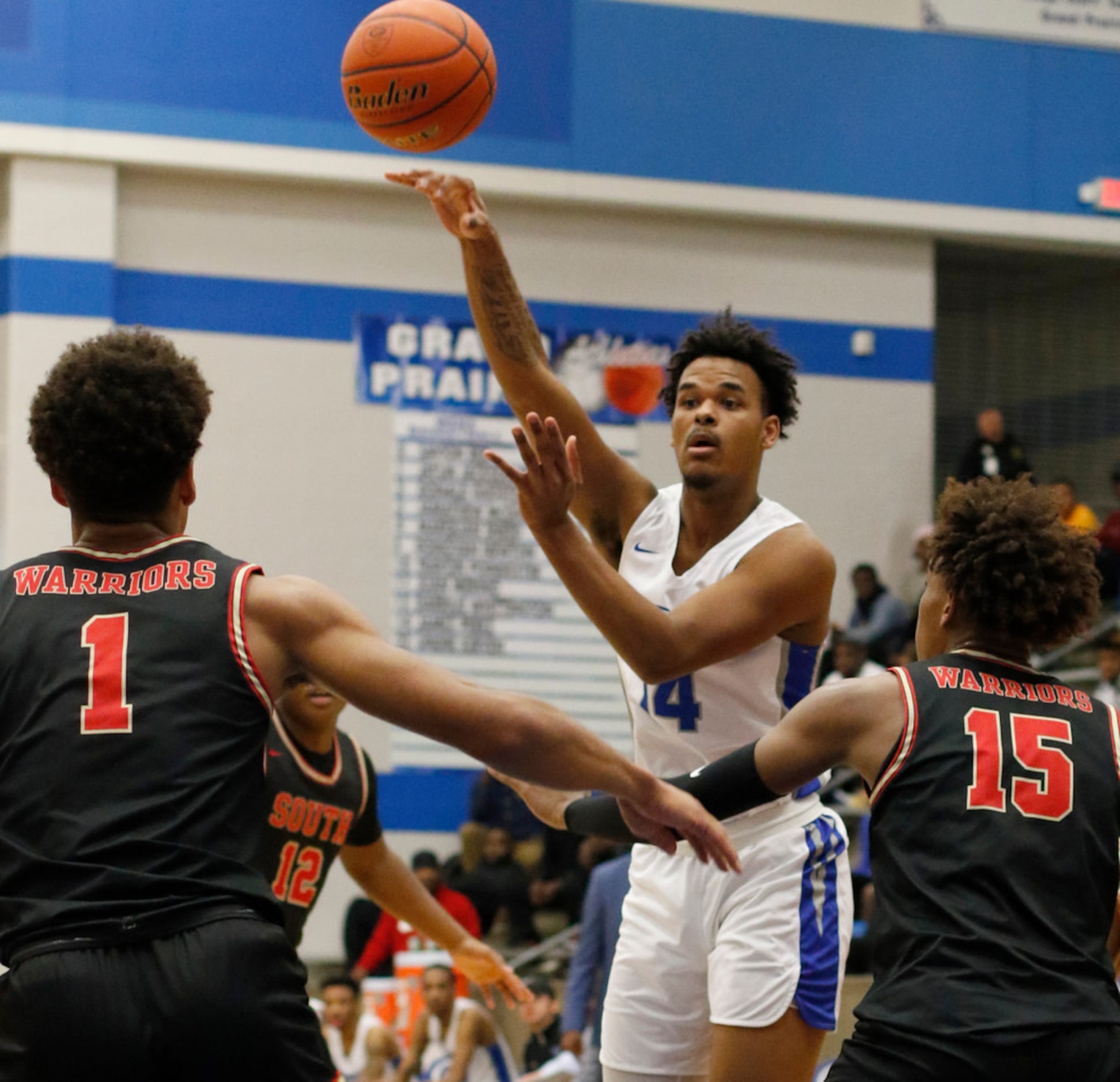 Grand Prairie's Anthony Solomon (14) passes around the defense of South Grand Prairie...