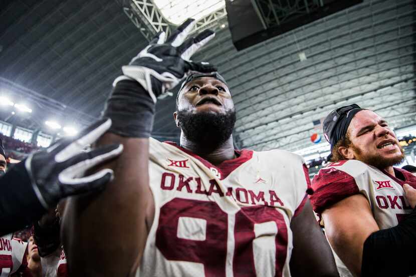 Oklahoma Sooners defensive lineman Neville Gallimore (90) celebrates winning the Big 12...